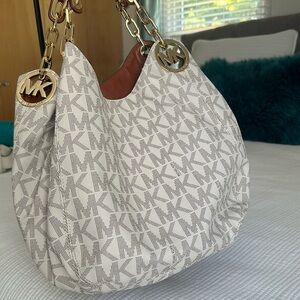 Michael Kors bag with gold hardware, has small marks on the handle see fotos.